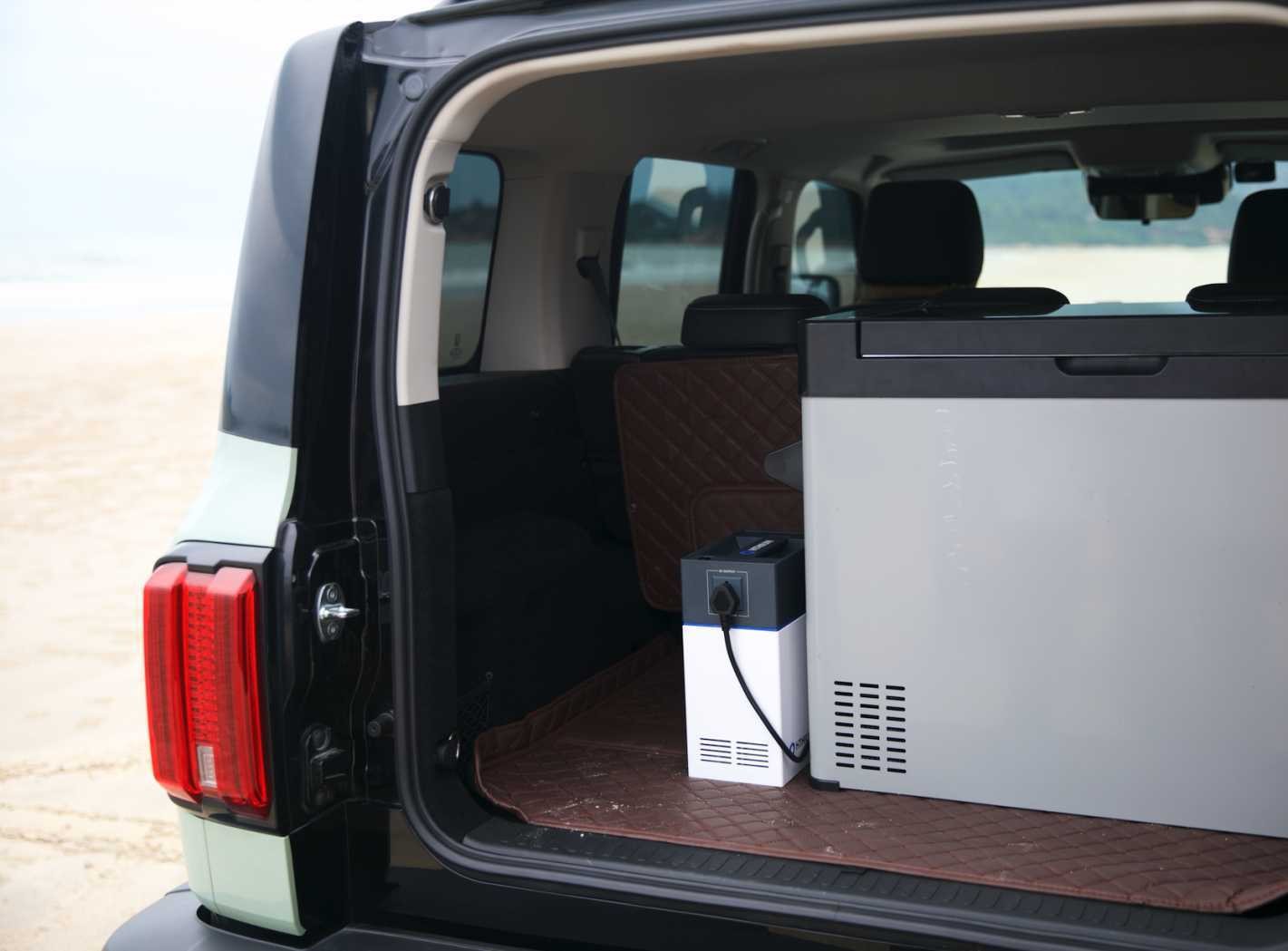 Portable power unit positioned in the rear of a vehicle